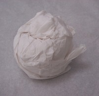 Tightly wrap your prize in tissue paper for your pumpkin craft.